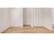 Image features 2 sets of closets with wood-look flooring near a bathroom at 12109 N 127Th Dr, El Mirage, AZ 85335