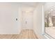 Bright entryway with light wood flooring and ample natural light from a window with blinds at 12109 N 127Th Dr, El Mirage, AZ 85335