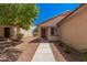 Inviting entryway with covered porch and desert landscaping leading to a secure front door at 12109 N 127Th Dr, El Mirage, AZ 85335