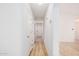 Hallway with light walls and wood-look floors leading to the main door at 12109 N 127Th Dr, El Mirage, AZ 85335