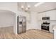 Bright, modern kitchen with stainless steel appliances, white cabinets and light wood flooring at 12109 N 127Th Dr, El Mirage, AZ 85335