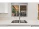 Close-up of a stainless steel sink and modern faucet with a view of the backyard at 12109 N 127Th Dr, El Mirage, AZ 85335