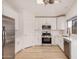 Open kitchen featuring stainless steel appliances, white cabinetry, and modern fixtures at 12109 N 127Th Dr, El Mirage, AZ 85335