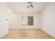 Open living space with wood flooring, ceiling fan and a large window providing natural light at 12109 N 127Th Dr, El Mirage, AZ 85335