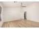 Spacious room featuring wood flooring, a ceiling fan, and arched doorways leading to other areas at 12109 N 127Th Dr, El Mirage, AZ 85335