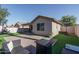 Entertainer's backyard offers a covered patio, paver area, and synthetic grass, complete with a basketball hoop at 13034 W Cheery Lynn Rd, Avondale, AZ 85392