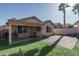 Inviting backyard oasis features a covered patio, brick pavers, and lush synthetic grass, perfect for outdoor entertaining at 13034 W Cheery Lynn Rd, Avondale, AZ 85392