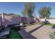 Beautiful backyard featuring pavers, synthetic grass, seating area and an umbrella for shade, great for outdoor lounging at 13034 W Cheery Lynn Rd, Avondale, AZ 85392