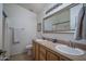 Bathroom features a double sink vanity, a large mirror, and a shower-tub combination at 13034 W Cheery Lynn Rd, Avondale, AZ 85392