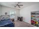Cozy bedroom with ceiling fan, window, and a desk for study at 13034 W Cheery Lynn Rd, Avondale, AZ 85392