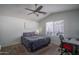 Bright bedroom features a ceiling fan, plush carpet, and a window for natural light at 13034 W Cheery Lynn Rd, Avondale, AZ 85392