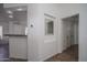 Hallway featuring neutral colors, tile flooring, and open access to the kitchen at 13034 W Cheery Lynn Rd, Avondale, AZ 85392