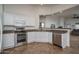 Functional kitchen features granite countertops, stainless steel appliances and white cabinets at 13034 W Cheery Lynn Rd, Avondale, AZ 85392