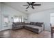 Bright and spacious living room features a large sectional sofa, a ceiling fan and access to back yard at 13034 W Cheery Lynn Rd, Avondale, AZ 85392