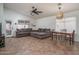 Spacious living room featuring vaulted ceilings, neutral paint, with a decorative ceiling fan and a dining table at 13034 W Cheery Lynn Rd, Avondale, AZ 85392