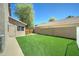 Artificial turf backyard with block fence and utility shed at 1361 E Sheffield Ave, Gilbert, AZ 85296