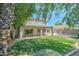 Spacious backyard with covered patio, green lawn, and view of the refreshing pool area at 1361 E Sheffield Ave, Gilbert, AZ 85296