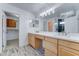 Modern bathroom features double sinks, a large mirror, and wood-look flooring at 1361 E Sheffield Ave, Gilbert, AZ 85296