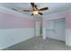 Bedroom with a ceiling fan and a built-in closet with a door at 1361 E Sheffield Ave, Gilbert, AZ 85296