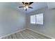 Neutral bedroom with light wood flooring, ceiling fan, and window offering natural light at 1361 E Sheffield Ave, Gilbert, AZ 85296