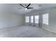 Spacious bedroom featuring a ceiling fan and a view from the three large windows at 1361 E Sheffield Ave, Gilbert, AZ 85296