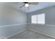 Neutral bedroom features a ceiling fan and a window for natural light at 1361 E Sheffield Ave, Gilbert, AZ 85296
