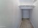 Small walk-in closet with beige carpet and shelving at 1361 E Sheffield Ave, Gilbert, AZ 85296