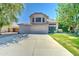 Inviting two-story home with a three-car garage, mature trees, and a well-manicured lawn at 1361 E Sheffield Ave, Gilbert, AZ 85296