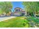 Lovely home with a three-car garage, lush green lawn, and mature trees providing shade at 1361 E Sheffield Ave, Gilbert, AZ 85296