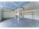 Spacious garage with overhead door, concrete floors, shelving, and water heater at 1361 E Sheffield Ave, Gilbert, AZ 85296