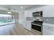 Bright, updated kitchen with stainless steel appliances and eat-in dining area overlooking the backyard at 1361 E Sheffield Ave, Gilbert, AZ 85296