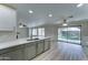 Open-concept kitchen offers gray cabinets, stainless appliances, and eat-in area with backyard access at 1361 E Sheffield Ave, Gilbert, AZ 85296