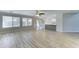 Open-concept living room with modern flooring, large windows, and an adjacent kitchen area at 1361 E Sheffield Ave, Gilbert, AZ 85296