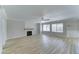 Spacious living room with a cozy fireplace, new flooring, and plenty of natural light at 1361 E Sheffield Ave, Gilbert, AZ 85296