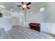 Bright living room with staircase, high ceiling, wood-look flooring, and a piano at 1361 E Sheffield Ave, Gilbert, AZ 85296