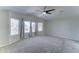 Expansive main bedroom features plush carpeting, a ceiling fan, and large windows at 1361 E Sheffield Ave, Gilbert, AZ 85296