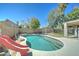 Inviting backyard pool with a slide, concrete patio, and partial fence for added privacy at 1361 E Sheffield Ave, Gilbert, AZ 85296