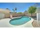 Backyard pool features a slide and is surrounded by a concrete patio, block wall, and lush landscaping at 1361 E Sheffield Ave, Gilbert, AZ 85296