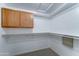 Walk-in closet features multiple shelving units and hanging rods for optimal storage at 1361 E Sheffield Ave, Gilbert, AZ 85296