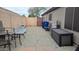 The backyard has gravel, a table with chairs, a storage box, and a light-blue bike at 14968 N 134Th Ln, Surprise, AZ 85379