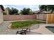The backyard has a lawn area, is surrounded by a block wall and gravel and has a lounge chair at 14968 N 134Th Ln, Surprise, AZ 85379