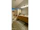 Bathroom featuring double sinks, wood cabinets, and a shower-tub combo with updated fixtures at 14968 N 134Th Ln, Surprise, AZ 85379
