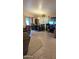Open-concept dining area with modern table, chairs, and view of the backyard at 14968 N 134Th Ln, Surprise, AZ 85379