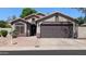Charming single-story home with a two-car garage and desert landscaping at 14968 N 134Th Ln, Surprise, AZ 85379