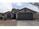 Charming single-story home with a well-manicured front yard and a two-car garage at 14968 N 134Th Ln, Surprise, AZ 85379