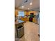 Well-lit kitchen featuring wooden cabinets, granite countertops, and stainless steel appliances at 14968 N 134Th Ln, Surprise, AZ 85379