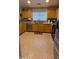Functional kitchen featuring wooden cabinets, granite countertops, and stainless steel appliances at 14968 N 134Th Ln, Surprise, AZ 85379