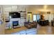 Spacious living room with a fireplace, ceiling fan, and access to the dining area at 14968 N 134Th Ln, Surprise, AZ 85379