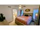 Warm main bedroom with bed, ceiling fan, and bathroom access at 14968 N 134Th Ln, Surprise, AZ 85379