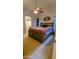 Bedroom features a ceiling fan, large bed, and connected bathroom at 14968 N 134Th Ln, Surprise, AZ 85379